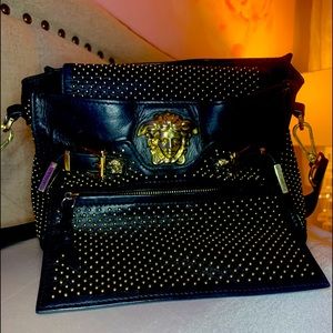 Versace black leather purse with small gold studs.